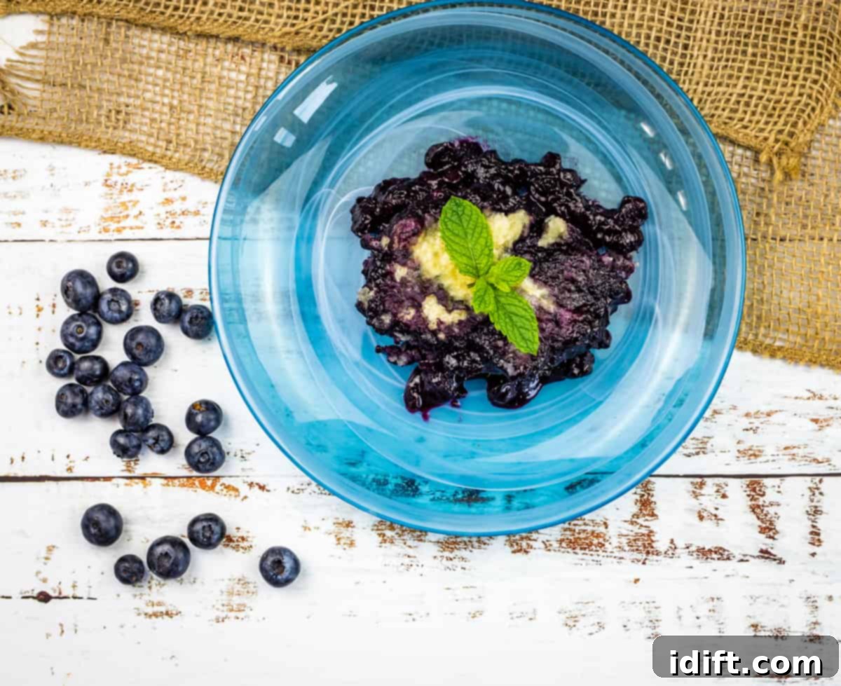 9 Canadian Classics: More Than Maple Syrup 2 Blueberry Grunt on a blue plate with ice cream.