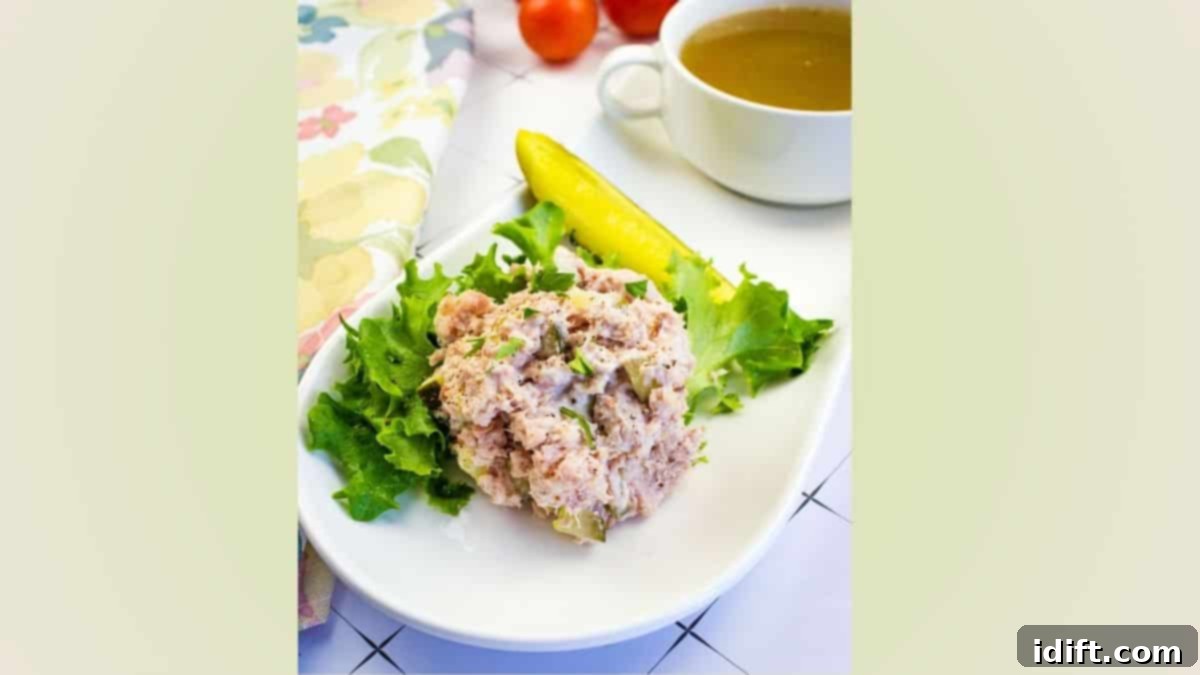 Old Fashioned Ham Salad with dill pickle on a plate.