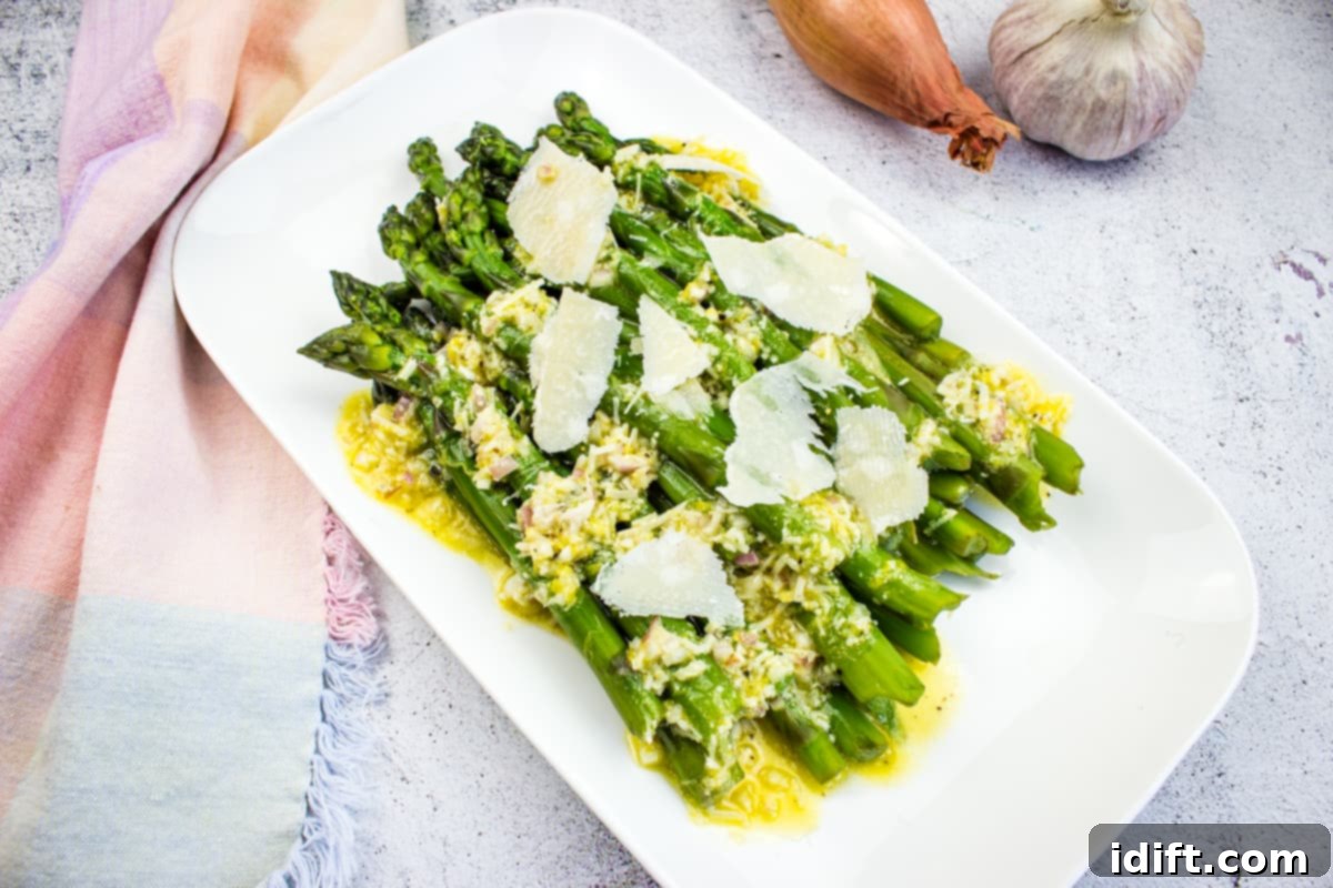 Asparagus with Lemon and Parmesan on a white platter.