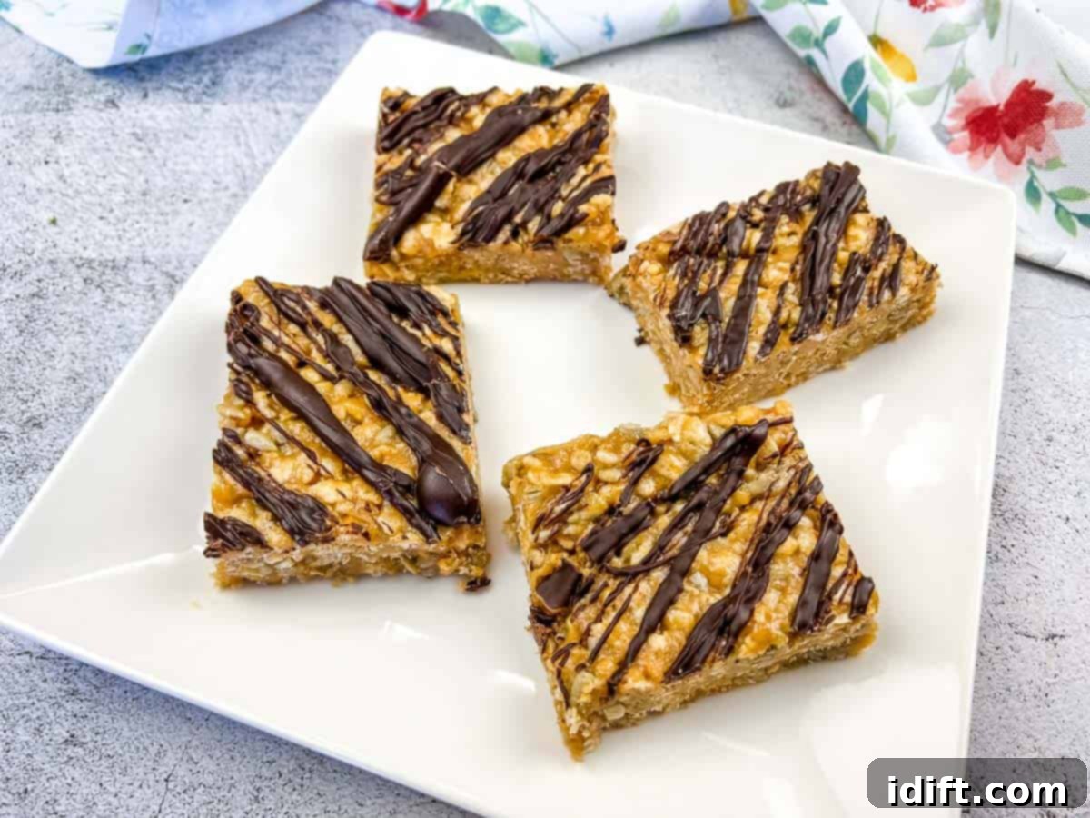 Four pieces of molly bars on a white plate, showcasing a delightful golden brown color and a crumbly topping.