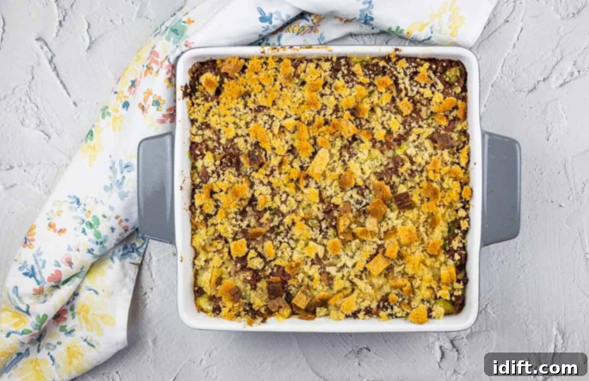 15 Stylish Casseroles That Redefine Comfort Food 9 Corned Beef Hash Casserole in a square baking dish, a savory re-imagining of a classic.