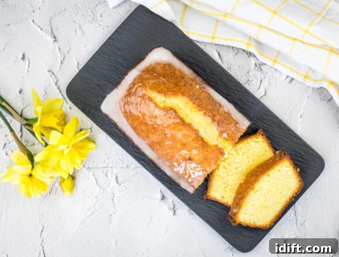 17 Refreshing Spring Recipes to Delight Your Senses 5 A slice of lemon pound loaf on a plate with daffodils.