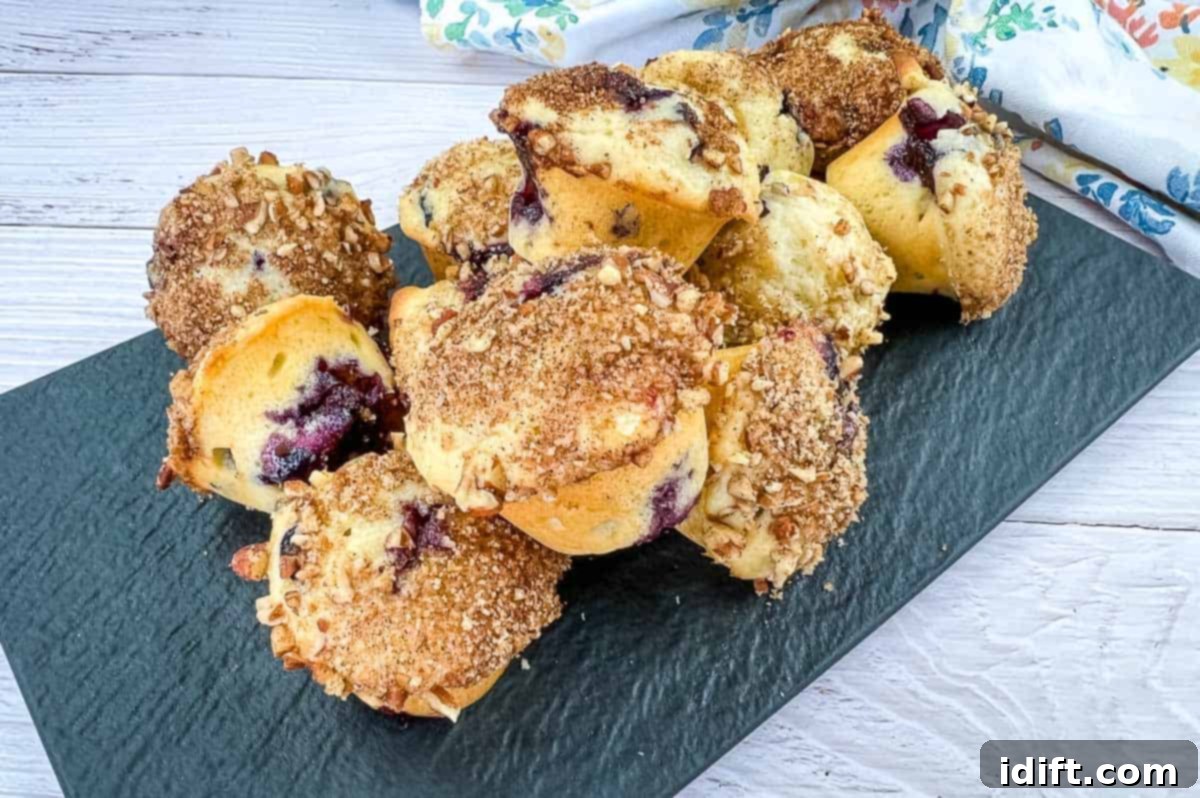 15 Vibrant Spring Dishes That Will Entice You to Dine Al Fresco 5 Blueberry crumb muffins on a white plate.