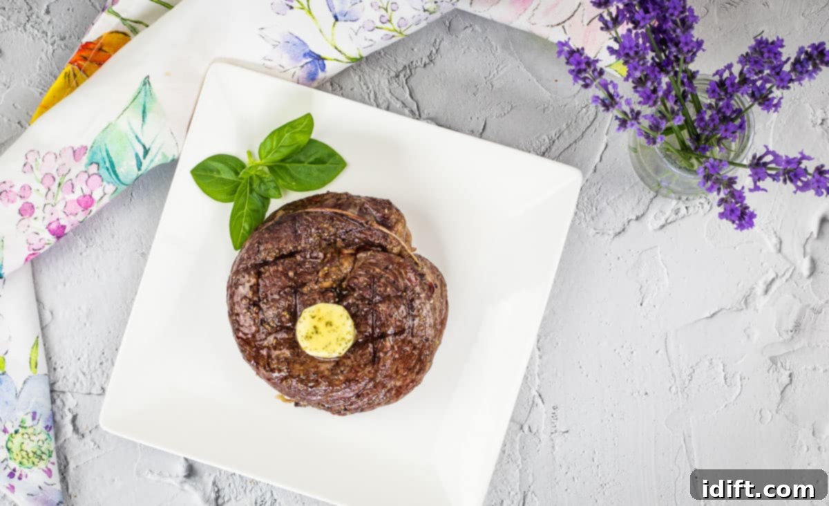 11 Surprising Foods You Have to Try on the Grill 3 A top-down shot of Grilled Ribeye Cap Steak on a cutting board with veggies.