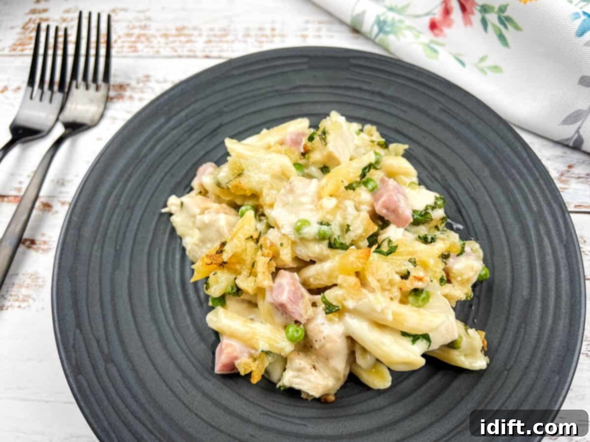Chicken cordon bleu casserole on a black plate with a fork.