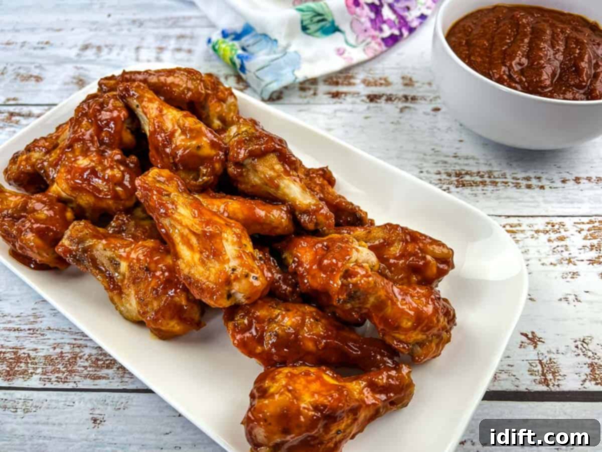 Grilled Wings with Jack Daniel's BBQ Sauce artfully arranged on a white plate.
