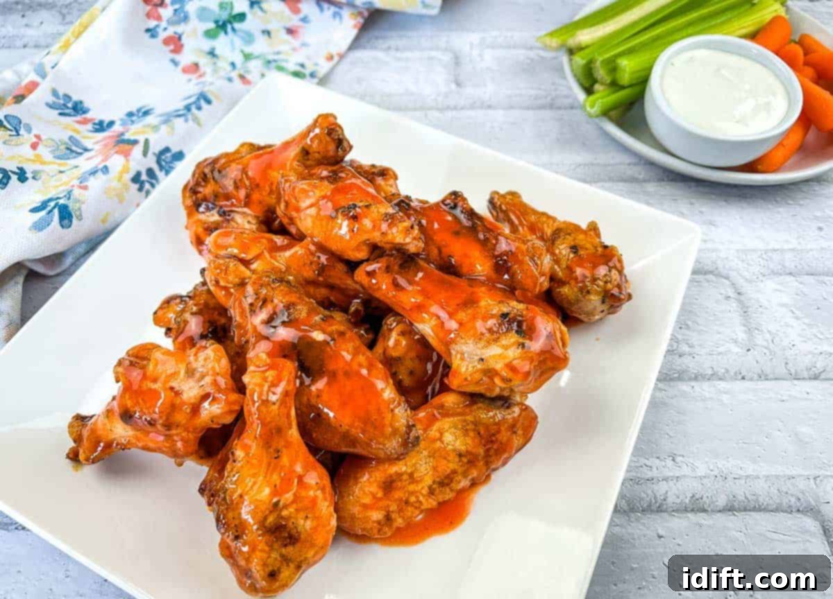 Grilled Chicken Wings with Buffalo Sauce, served with celery and carrot sticks.