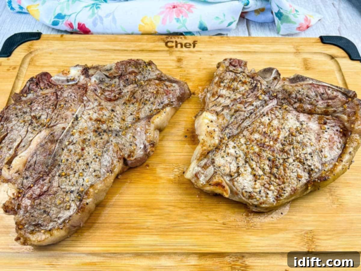 Taste The Heat: 17 Grilling Recipes To Ignite Your Weekend 14 A perfectly grilled T-Bone steak, showcasing the delicious combination of tenderloin and strip steak, served on a sophisticated black platter.