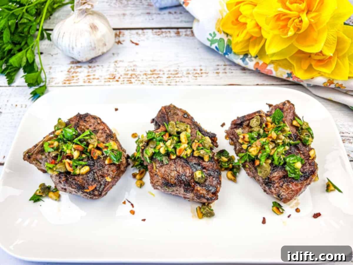 15 Grilled Meats Your Taste Buds Will Thank You For 13 Three Ninja Woodfire Grill Mediterranean Lamb Chops topped with gremolata on a white plate.