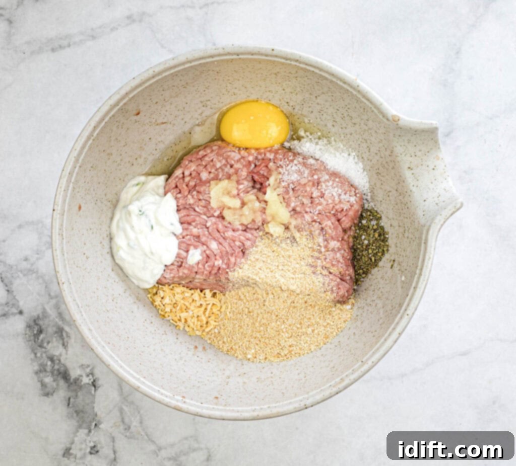 Mediterranean Meatball Pita Pockets 6 Mixing the ground meat mixture in a bowl.