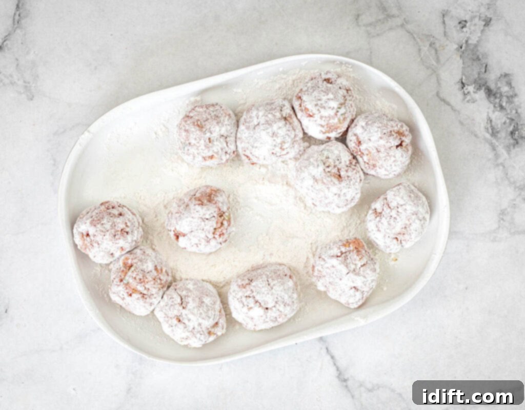 Mediterranean Meatball Pita Pockets 9 Coating meatballs in flour.