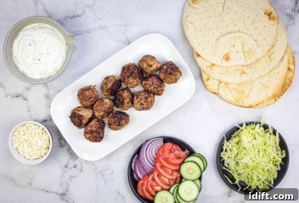 Mediterranean Meatball Pita Pockets 10 Assembling the pita sandwich with tzatziki, meatballs, and fresh vegetables.