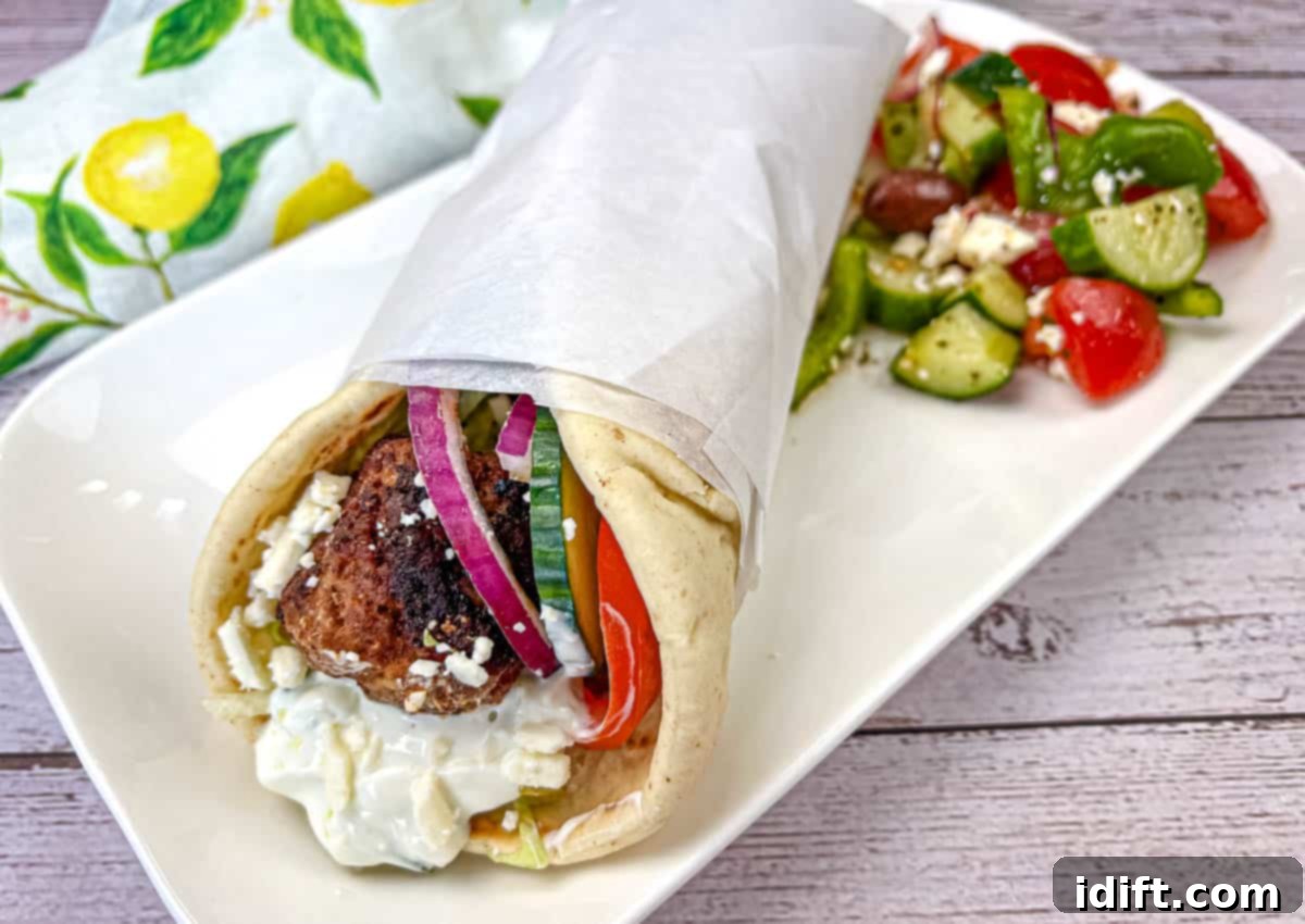 Speedy Suppers, Fabulous Flavors: Family Meals Made Easy 5 Greek Meatball Pita Sandwich served on a white rectangular plate.
