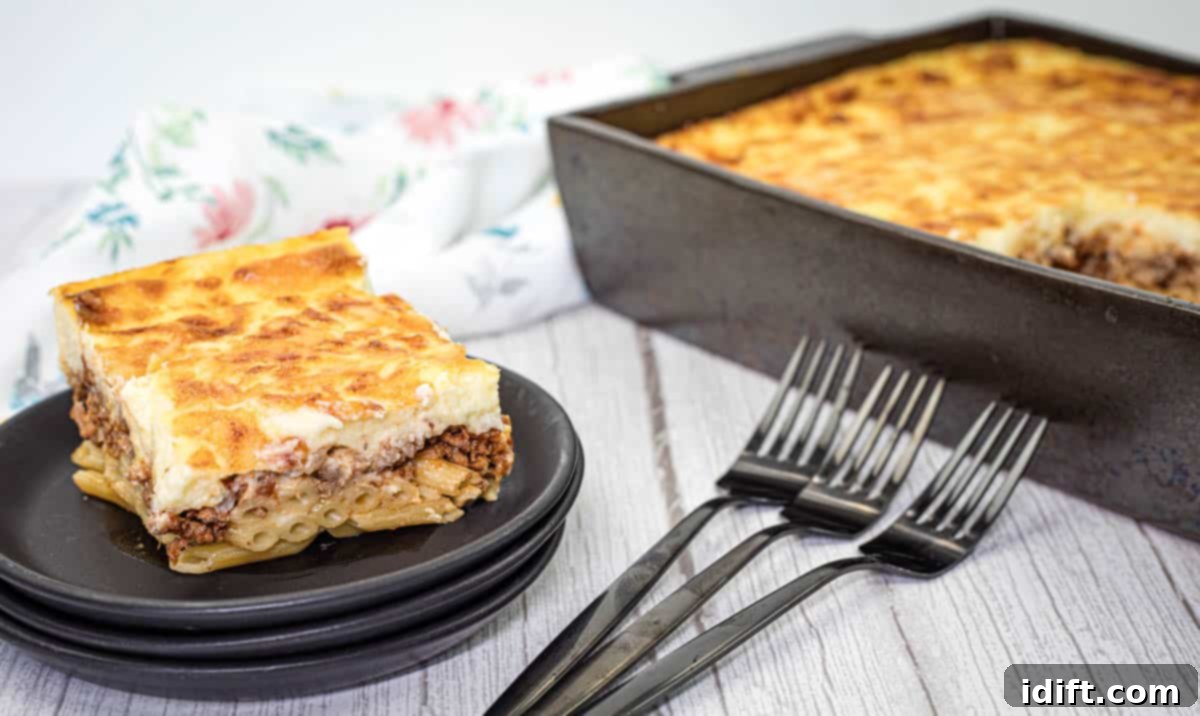 Speedy Suppers, Fabulous Flavors: Family Meals Made Easy 8 A square piece of pastitsio dish served on a stack of black plates.