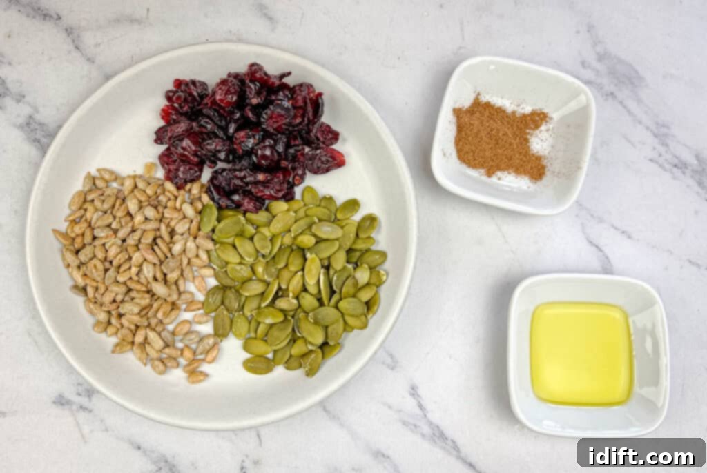 Golden Autumn Salmon Bowl 12 The distinct ingredients for the Harvest Crunch Topping, including dried cranberries, pumpkin seeds, sunflower seeds, pumpkin spice, and salt, presented neatly before being combined and toasted.