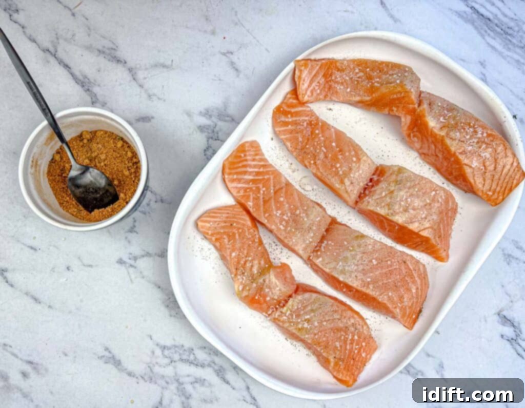 Golden Autumn Salmon Bowl 14 A salmon fillet, meticulously seasoned with salt and pepper, then sprinkled with a brown sugar and pumpkin spice mixture, poised for cooking to achieve a perfectly caramelized crust.