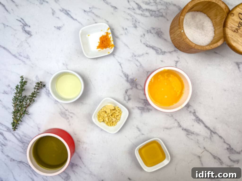 Golden Autumn Salmon Bowl 10 A collection of fresh ingredients used for the citrus dressing, including vibrant oranges and lemons, olive oil, honey, and a small container of mustard powder, highlighting their readiness for mixing.