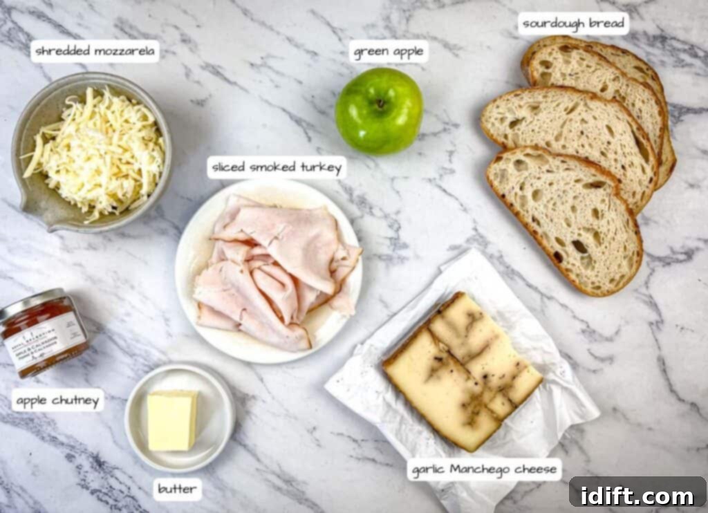 Artistically arranged ingredients for Turkey & Apple Grilled Cheese, clearly labeled for easy identification.