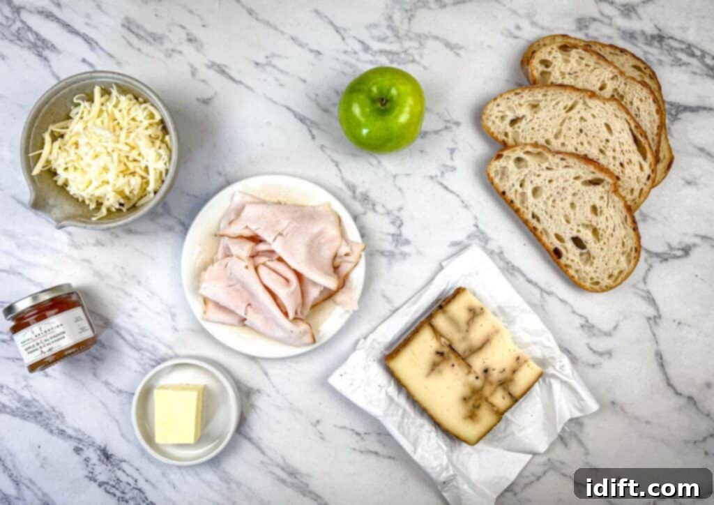 A selection of fresh ingredients laid out for making the Turkey & Apple Grilled Cheese.
