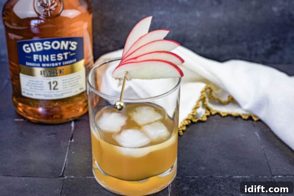 Homestyle Apple Pie Old Fashioned 3 A glass of Gibson’s Apple Pie Old Fashioned with sliced apple on top.