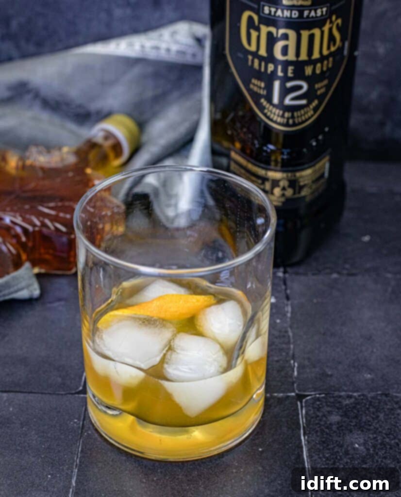 Grant’s Smoky Maple Sour on a glass, showcasing its rich amber hue.