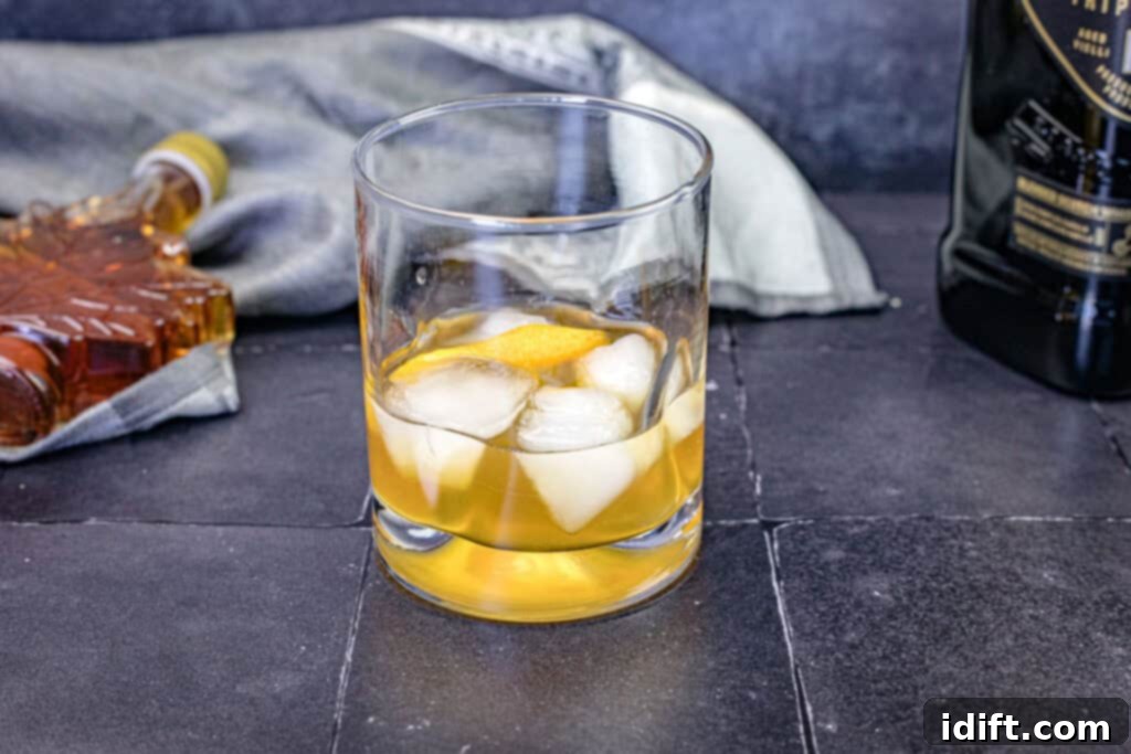 A close-up view of a glass of Grant’s Smoky Maple Sour, highlighting its refreshing appeal.