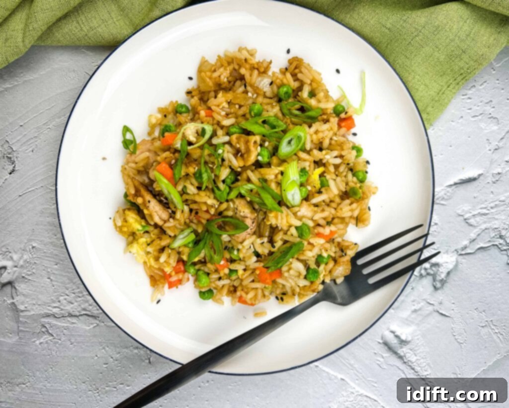 Anatolian Fried Rice 4 Turkey Fried Rice sizzling on a Blackstone Griddle, about to be transferred to a round plate.