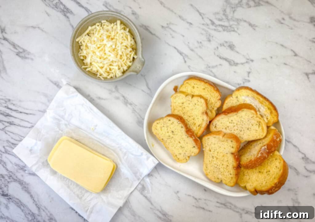 All the essential ingredients for Garlic Bread Grilled Cheese laid out: garlic bread, sliced cheese, and shredded mozzarella.