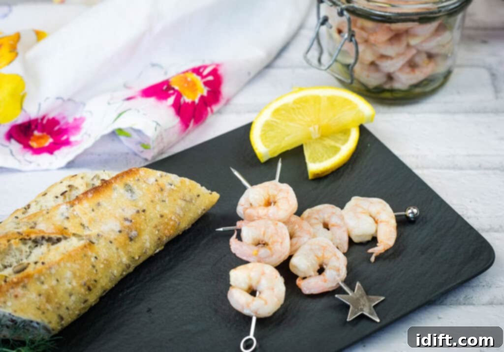 Pickled Shrimp artistically arranged on skewers with lemon slices on a black serving plate.