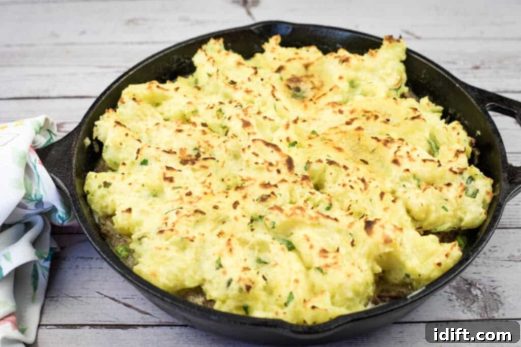 A golden brown Skillet Ground Beef Stroganoff Pie on a rustic wooden table, ready to be served.