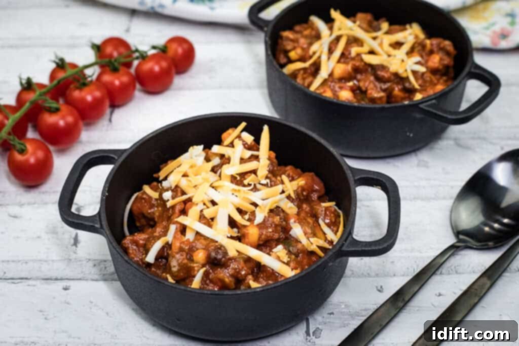 Slow Cooker Southwestern Chili served in a black skillet, garnished.