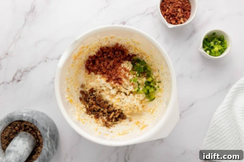 Stir in half the bacon bits, half the green onions, and half the chopped pecans. 