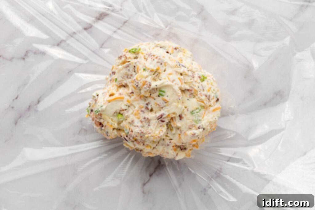 Wrap the cheese mixture tightly in the plastic wrap.