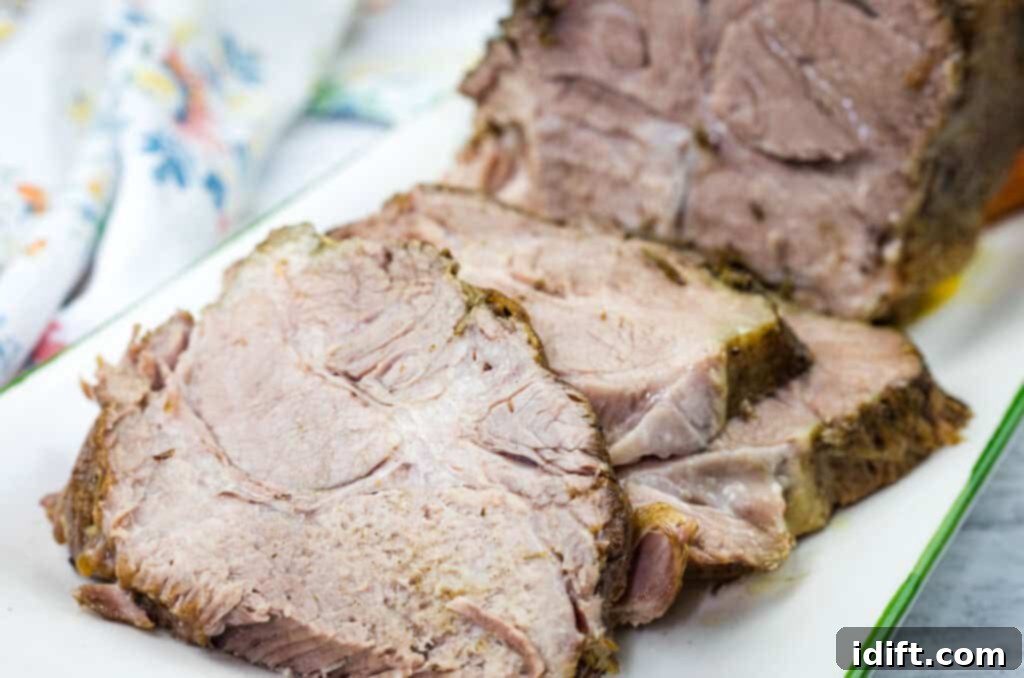 Slices of Slow Cooker Herb-Crusted Pork Roast on the plate.