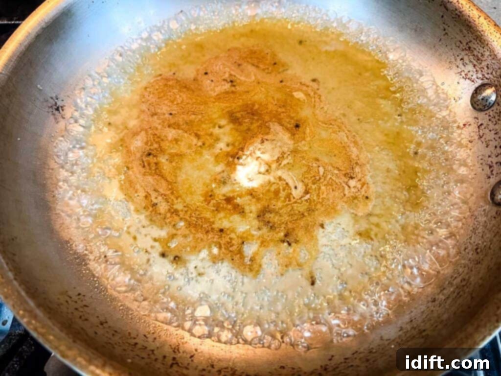 Deglaze the skillet by pouring in the white wine.