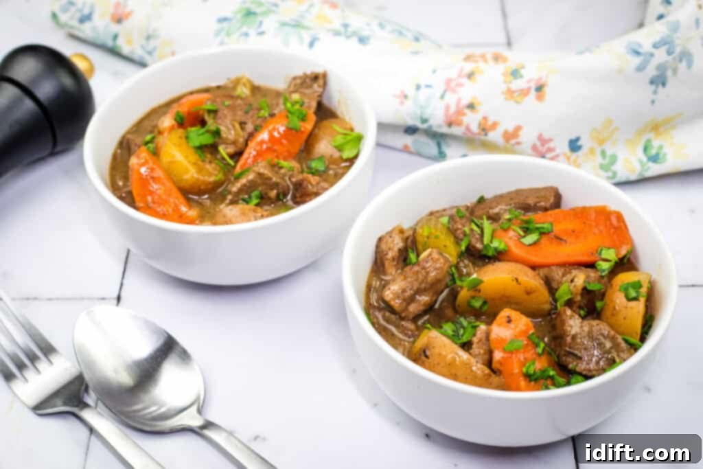 Two bowls of Classic Beef Stew topped with herbs.
