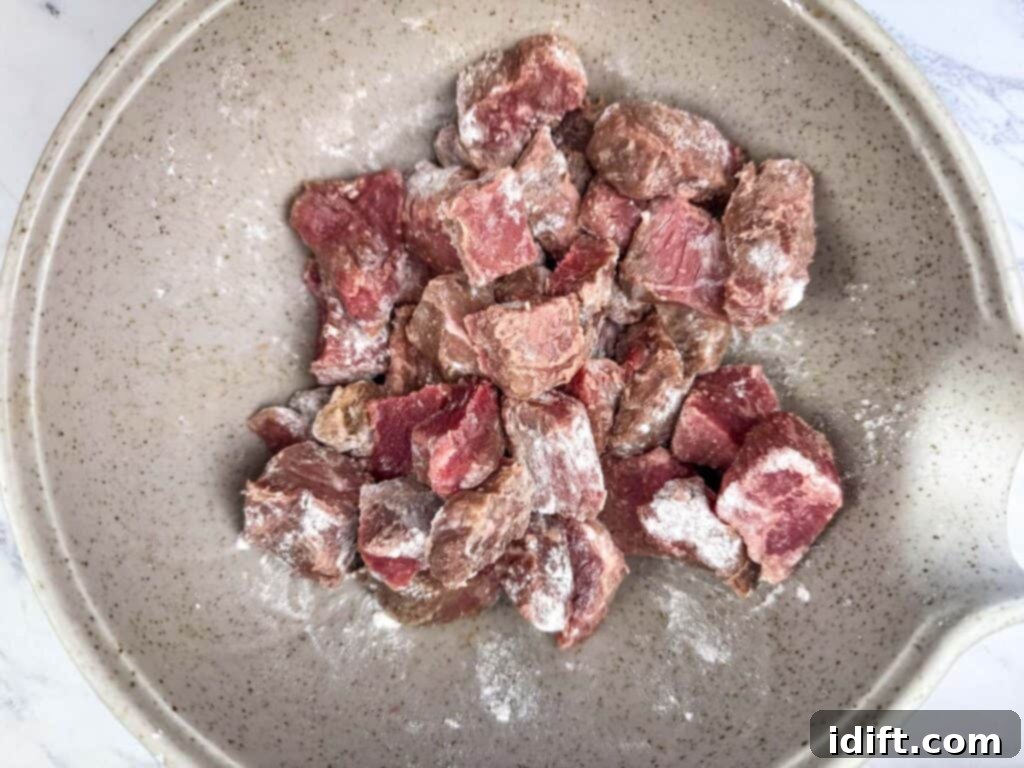 Toss the beef cubes in the flour mixture.