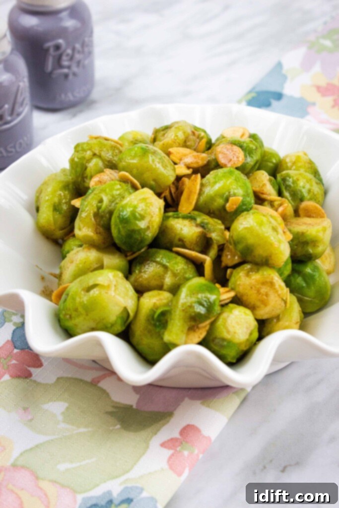 brussels sprouts with almonds and brown butter in a fluted serving bowl