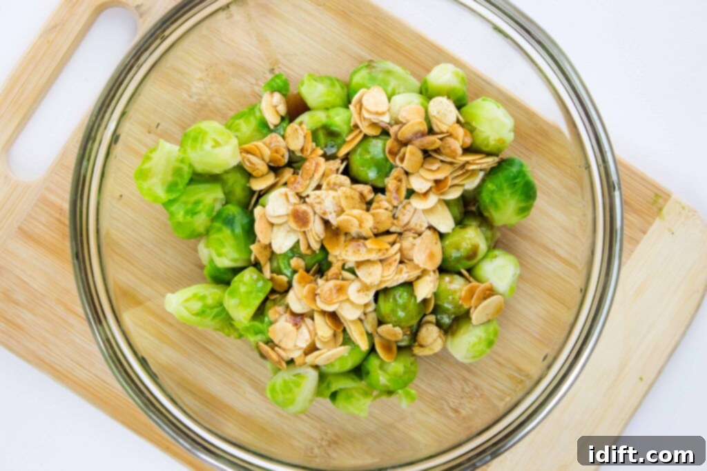the cooked brussels sprouts and almonds in a bowl ready to be combined.