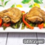 Roasted Garlic Chicken and Asparagus 10 garlic chicken and asparagus on a white plate