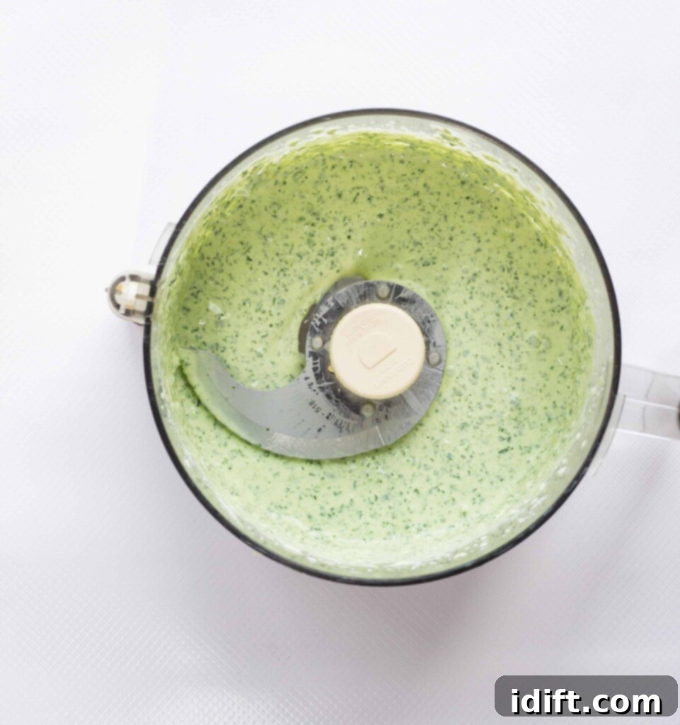 Zesty Jalapeño Cloud 6 A perfectly blended and smooth creamy jalapeno dip fills a food processor bowl, indicating it's ready to be served and enjoyed.