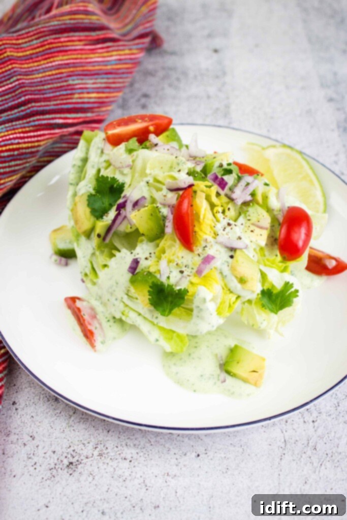 Zesty Jalapeño Cloud 7 A refreshing wedge salad beautifully topped with a generous dollop of creamy jalapeno dip, served on a white plate.