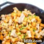 A serving of Sweet Potato Hash with Pulled Pork in black skillet.