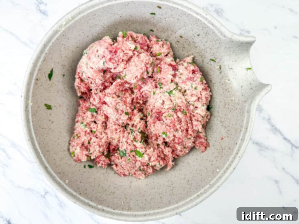 Cloud-Like Ricotta Meatballs with Rich Tomato Sauce 8 A bowl showing the mixed ricotta base with ground beef, ground pork, and egg, along with a half teaspoon of salt, ready to be formed.