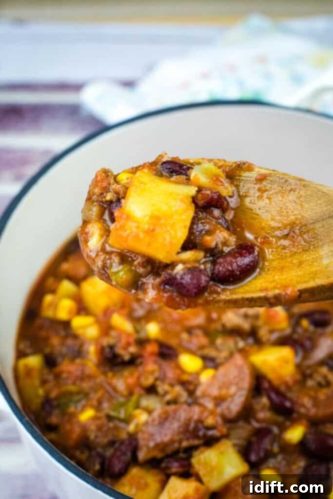 Robust Texas Campfire Stew 2 A wooden spoon with a Texas Cowboy Stew from a casserole.