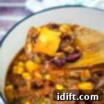 Robust Texas Campfire Stew 11 A wooden spoon with a Texas Cowboy Stew from a casserole.