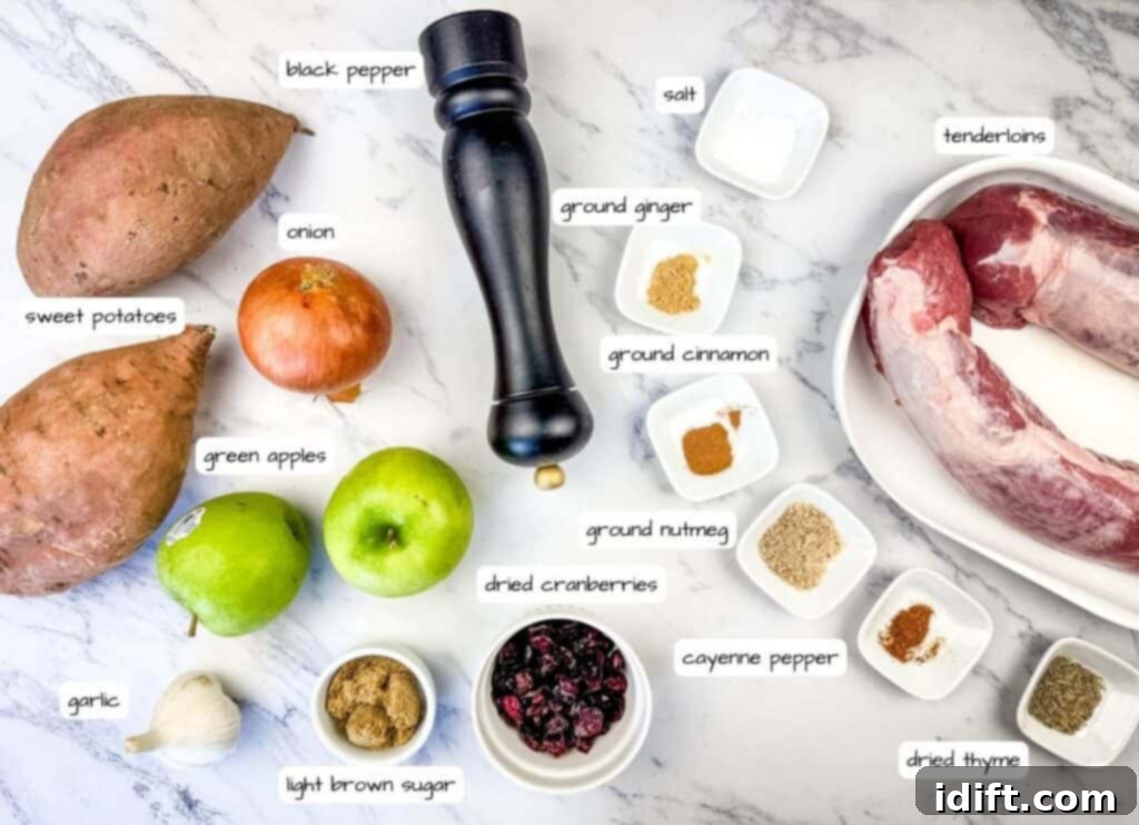 All the fresh and spice ingredients for Slow Cooker Pork Tenderloin with Sweet Potatoes & Apples laid out on a table with labels for easy identification.