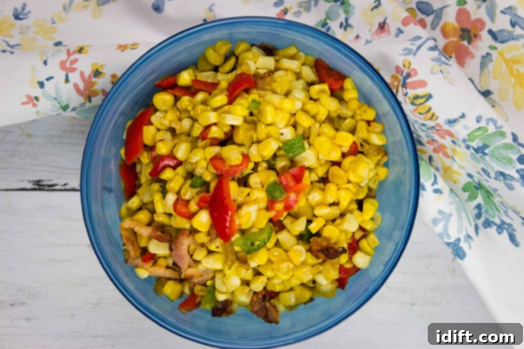 Texas corn succotash in a blue serving bowl with a floral napkin in the background