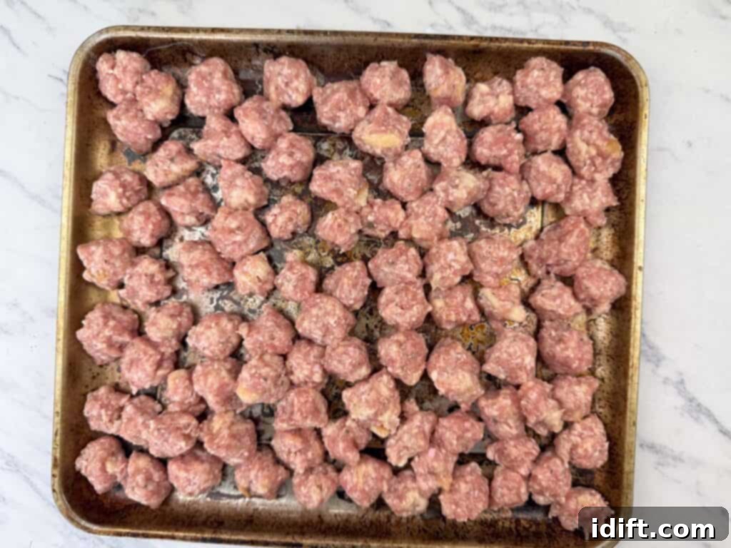 Scoop out small portions of the mixture and shape them into meatballs.