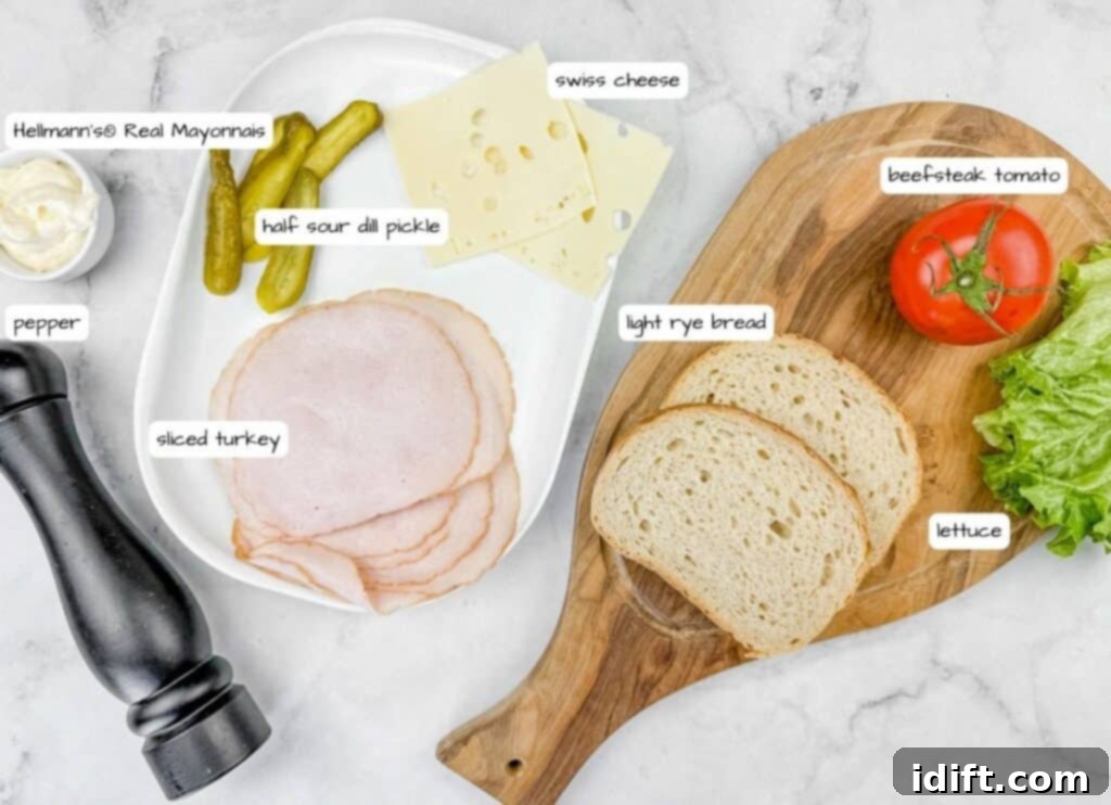 Labeled ingredients for What She's Having a Sandwich on a wooden board and plate on top of white marble countertop.